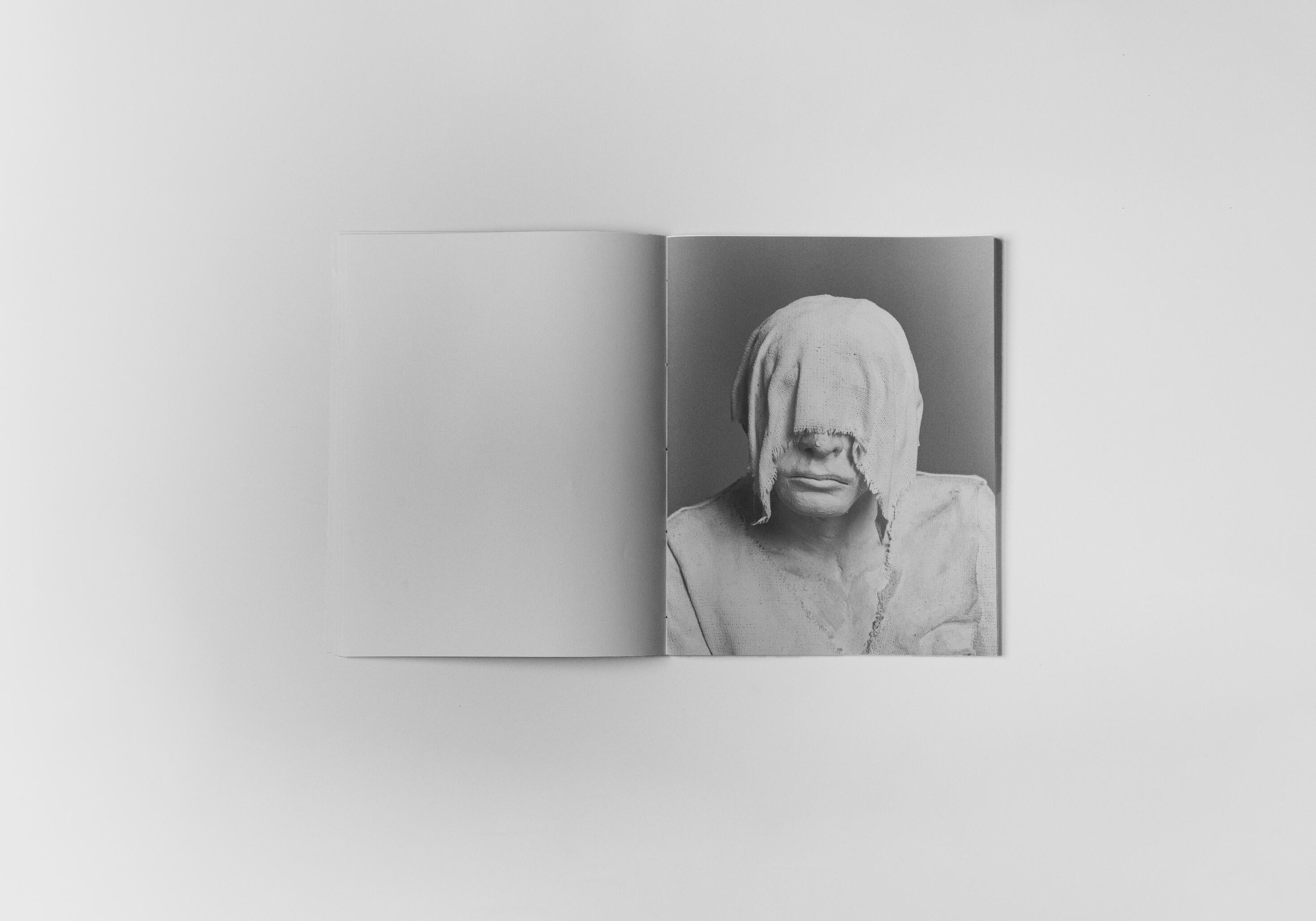 art book with sculpture of a flower emerging from a hand by Gabrielle Carrère