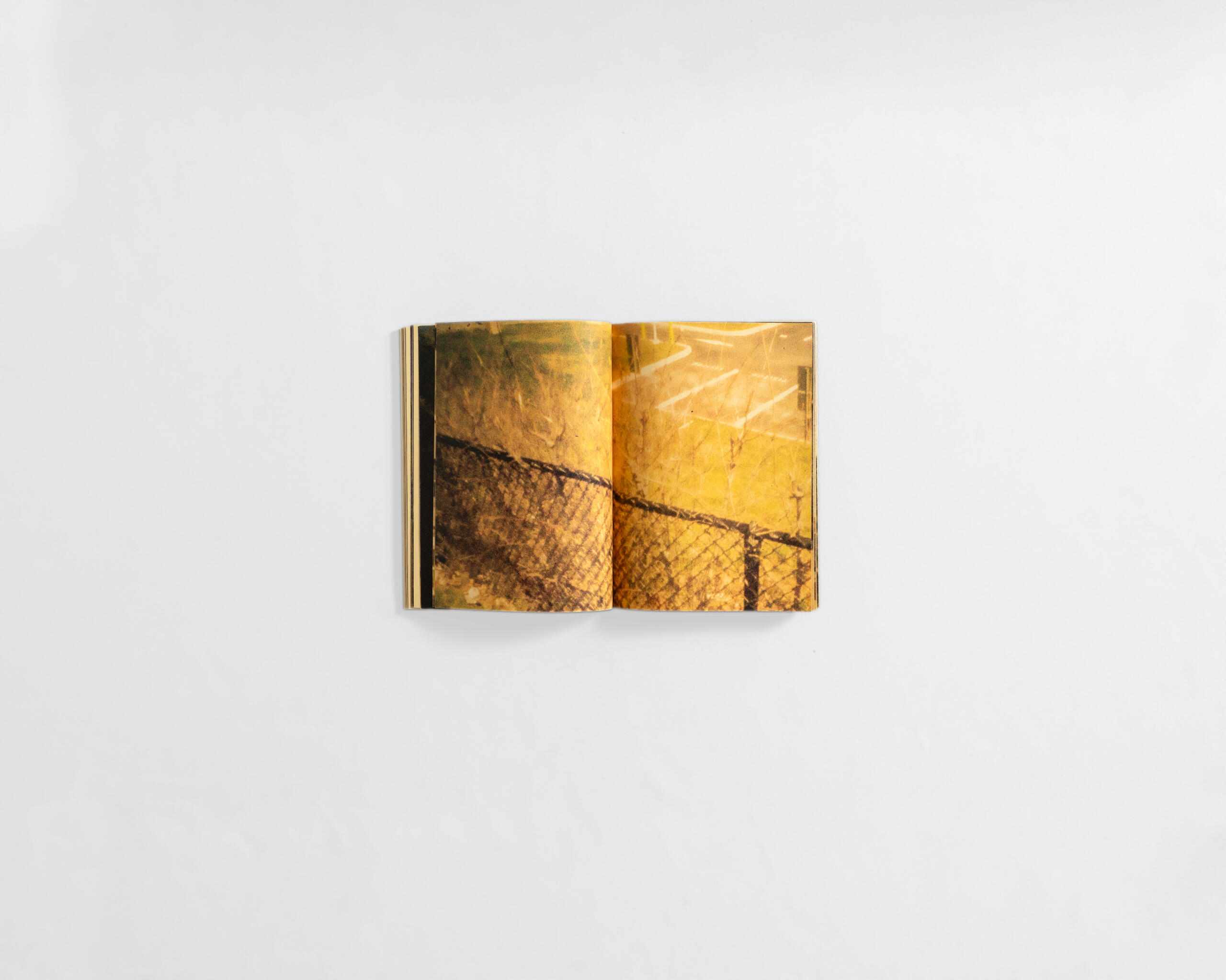 art book with fuzzy colourful image of fence