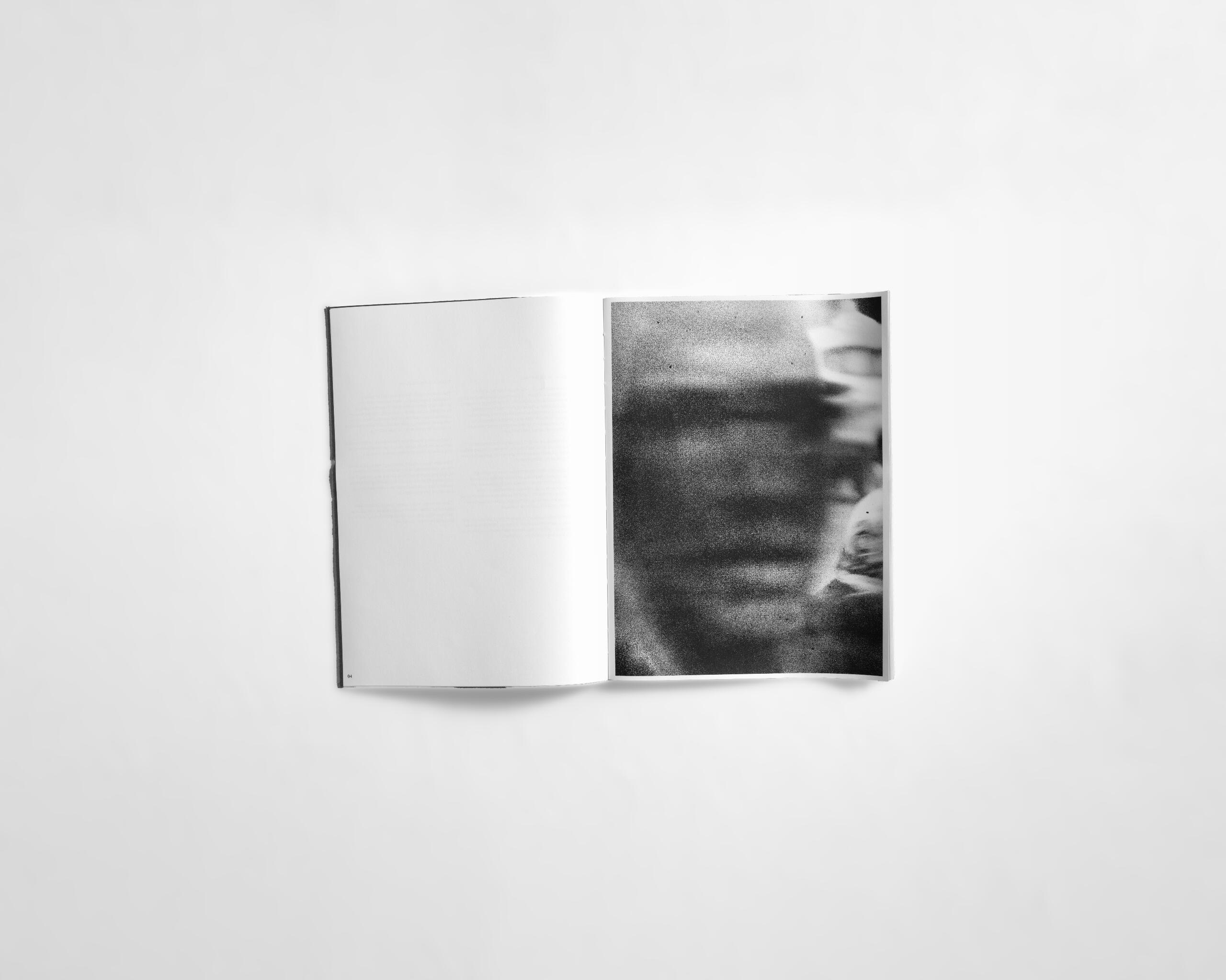 art book with abstract black and white image of a mysterious face