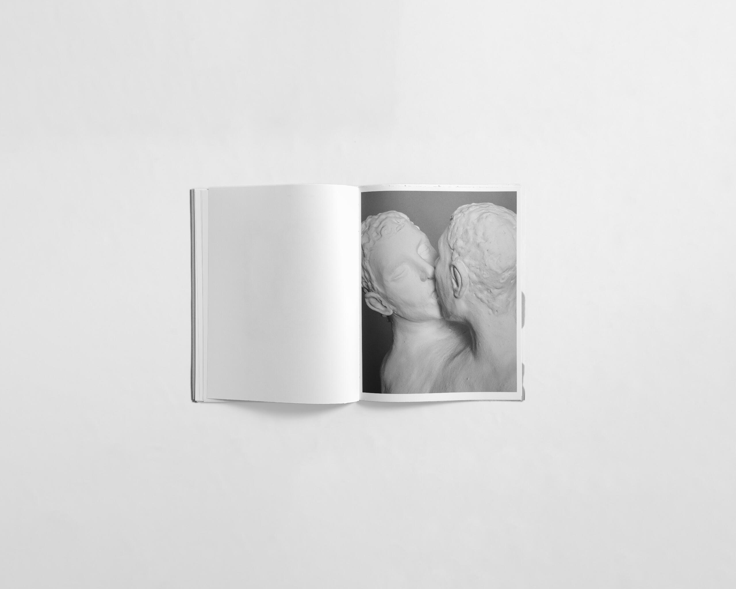 art book with sculpture of two people kissing by Gabrielle Carrère